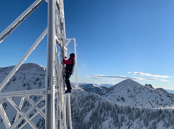 employee working on chairlift tower